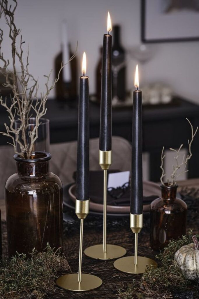 Gold Candle Holders on Black Shelves